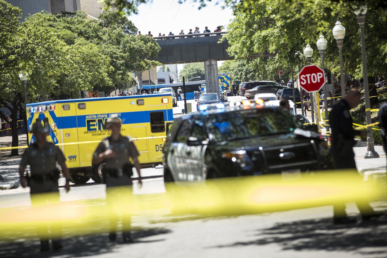 Emergency services personnel respond to the scene outside Gregory Gym where four students were stabbed, one fatally. 